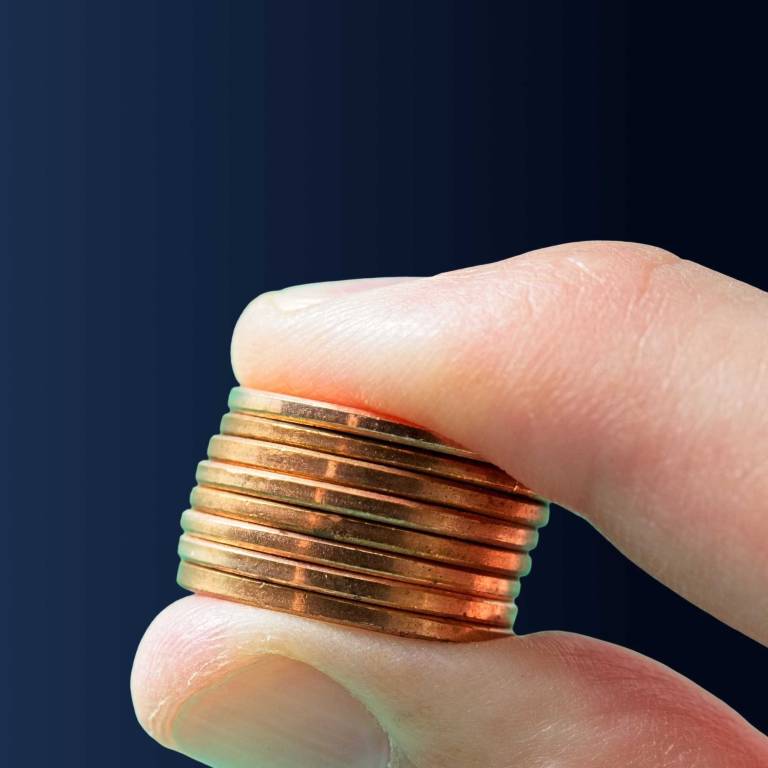 hand squeezing a small stack of coins to illustrate the penny-pinching consequences of delaying SEO investmenthand squeezing a small stack of coins to illustrate the penny-pinching consequences of delaying SEO investment