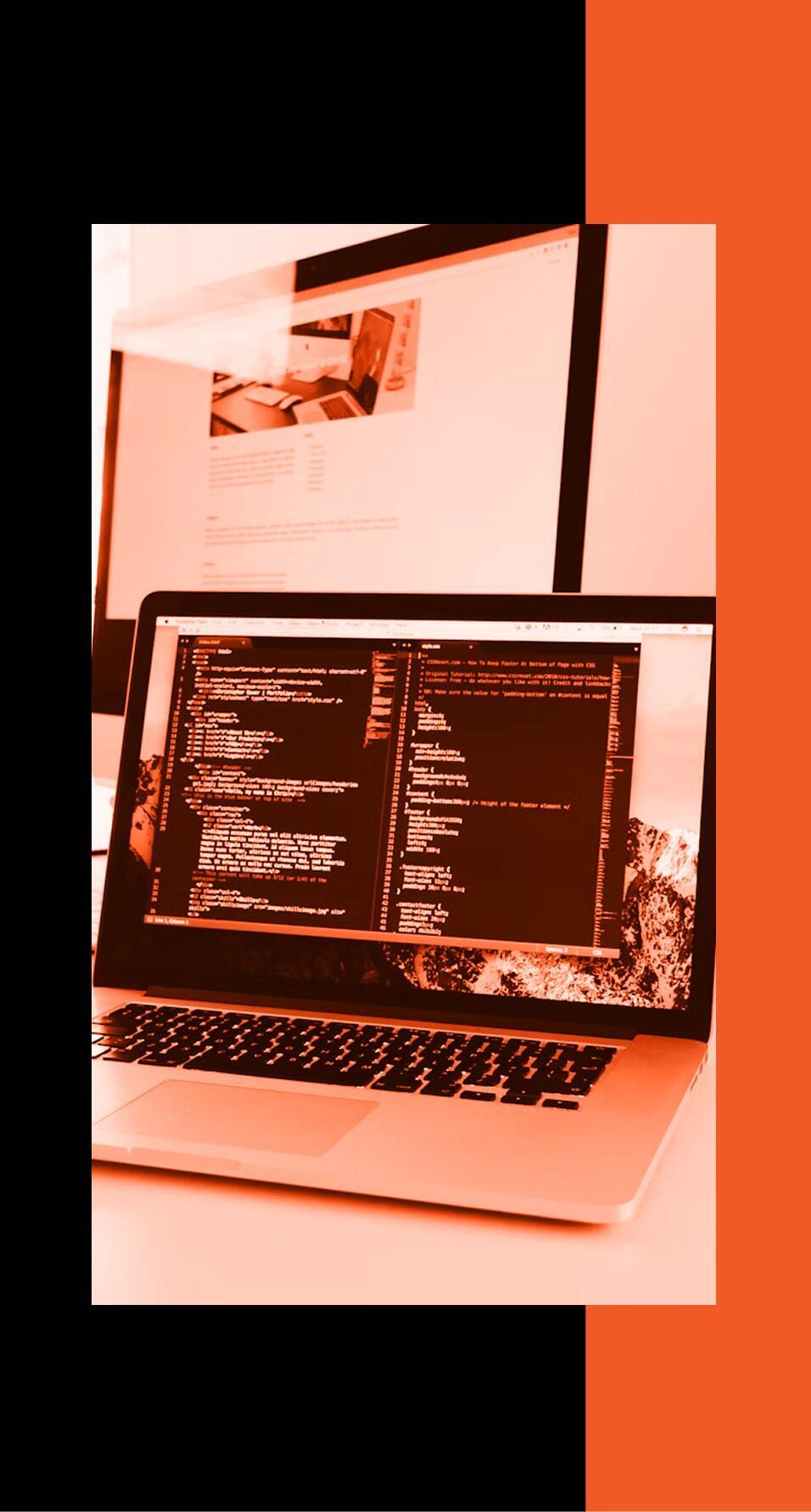 Laptop sitting on a desk with an orange filter and black and orange background