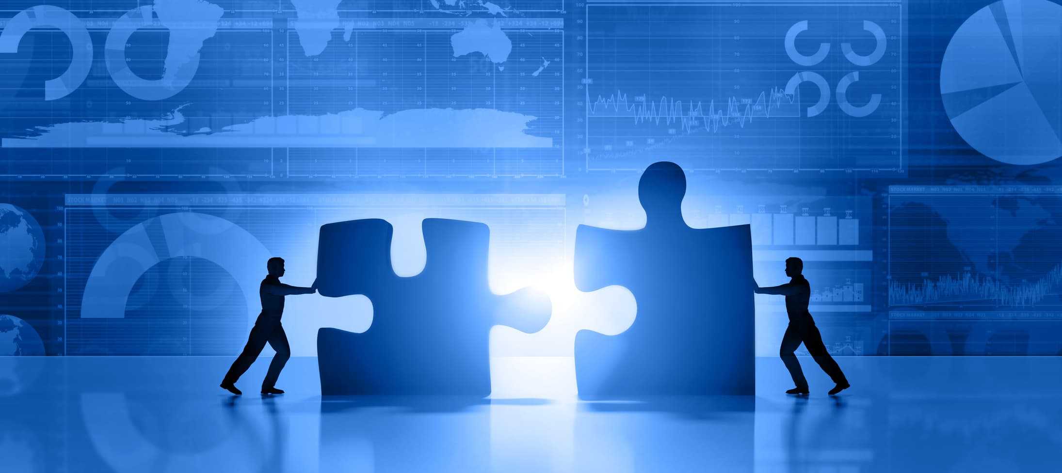 two people moving puzzle pieces together to represent business alignment