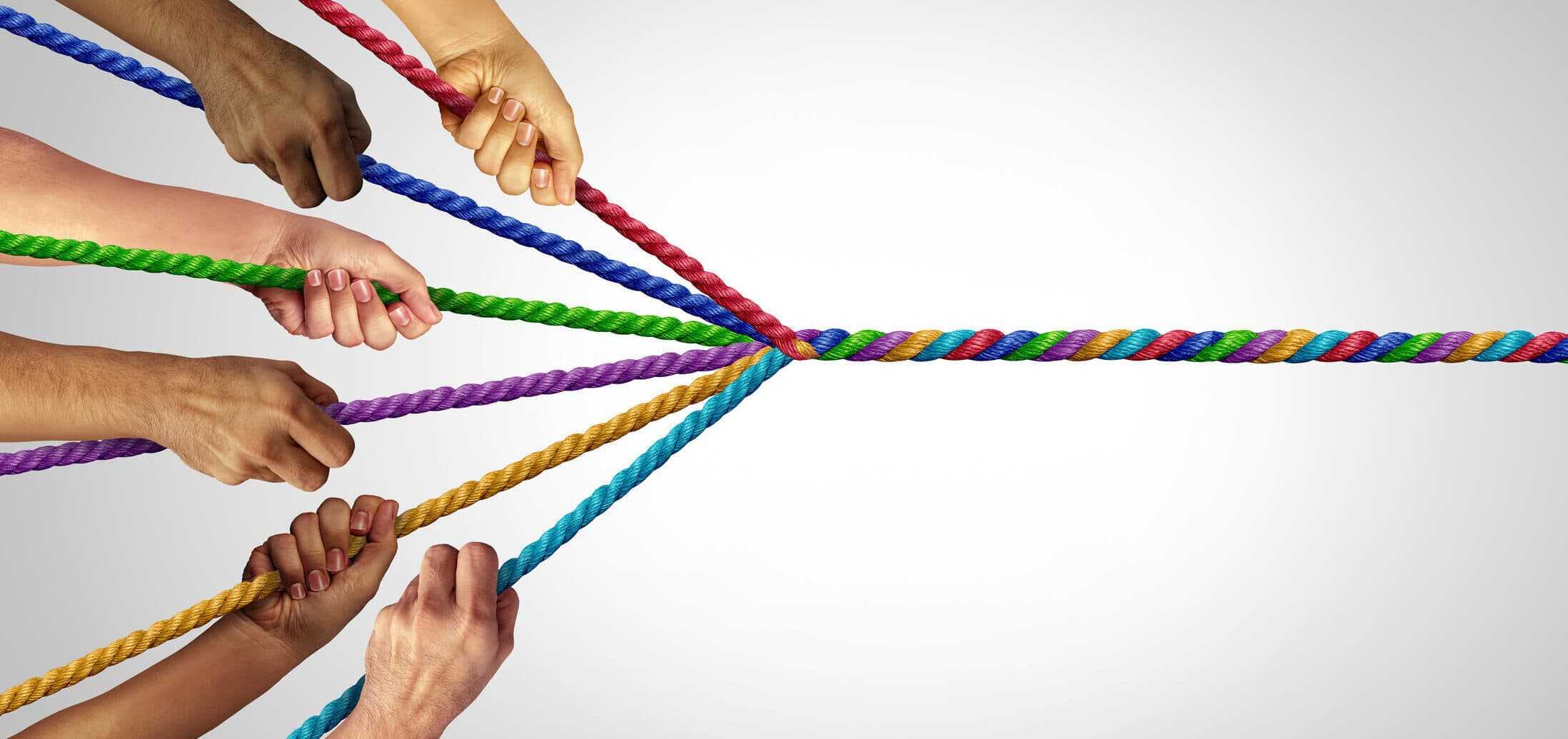 multiple hands pulling different colored ropes that twist into one unified rope representing cross‑functional teamwork in b2b ecommerce