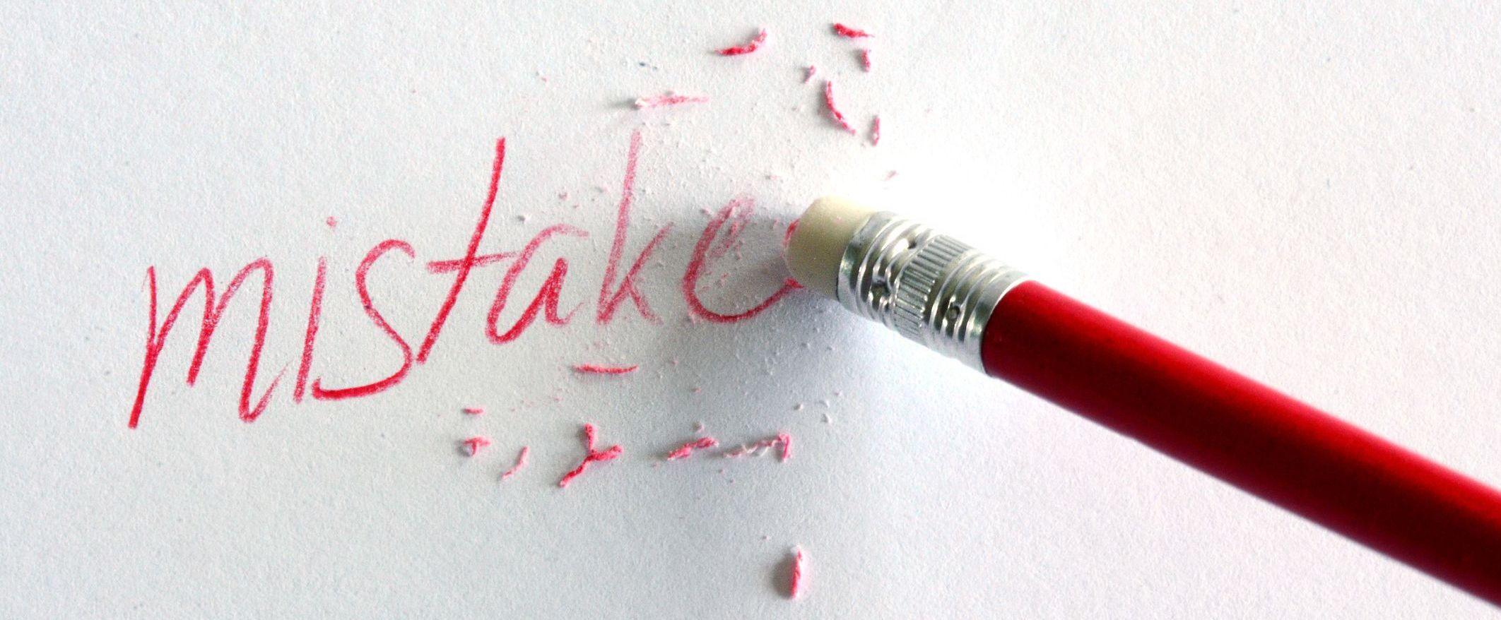 Pencil erasing the word mistake