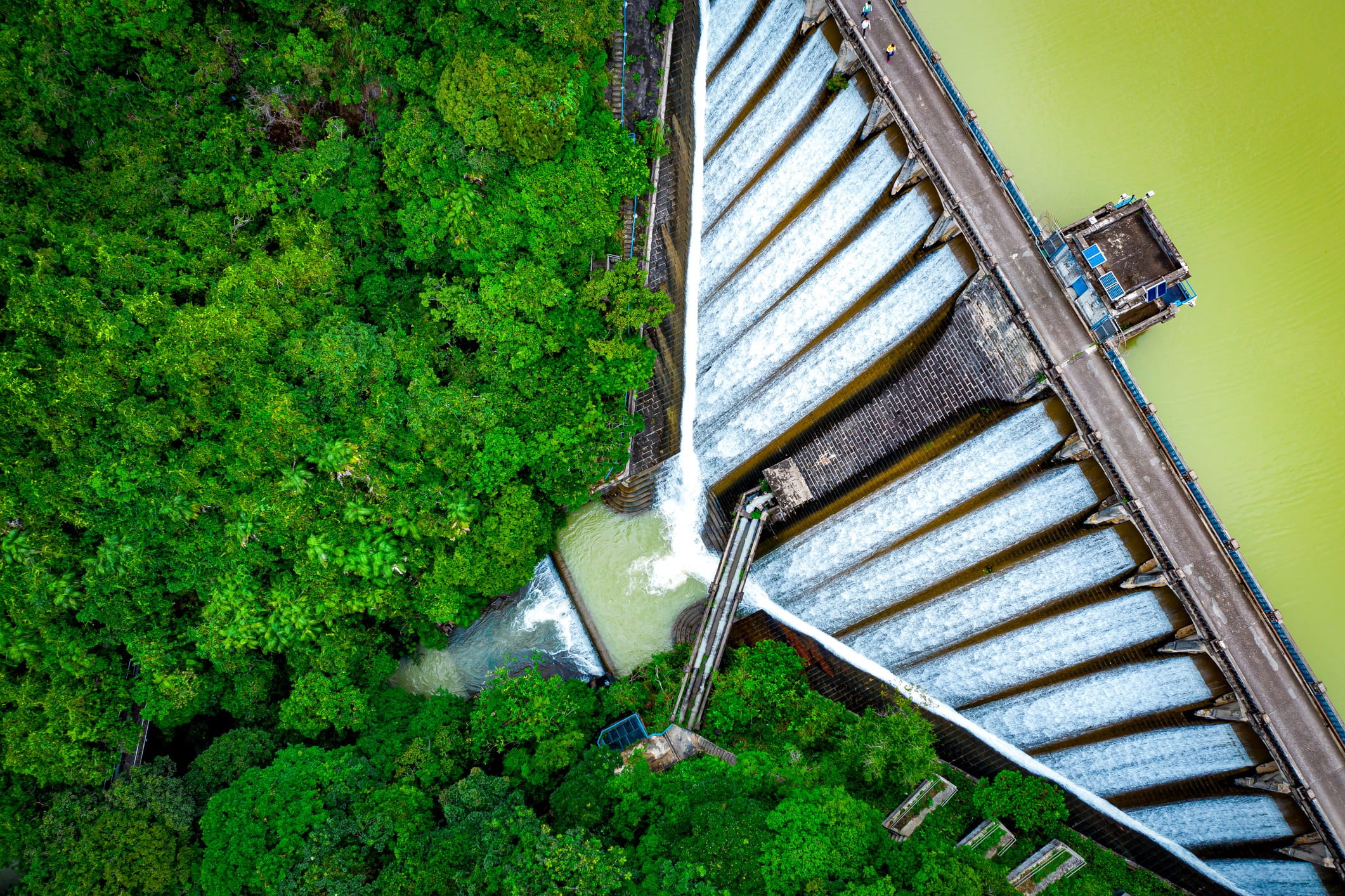 aerial view of a dam releasing water in steady, controlled channels representing a visual metaphor for inbound marketing systems that regulate demand, guide prospects through intentional pathways, and convert high‑intent traffic into predictable lead flow