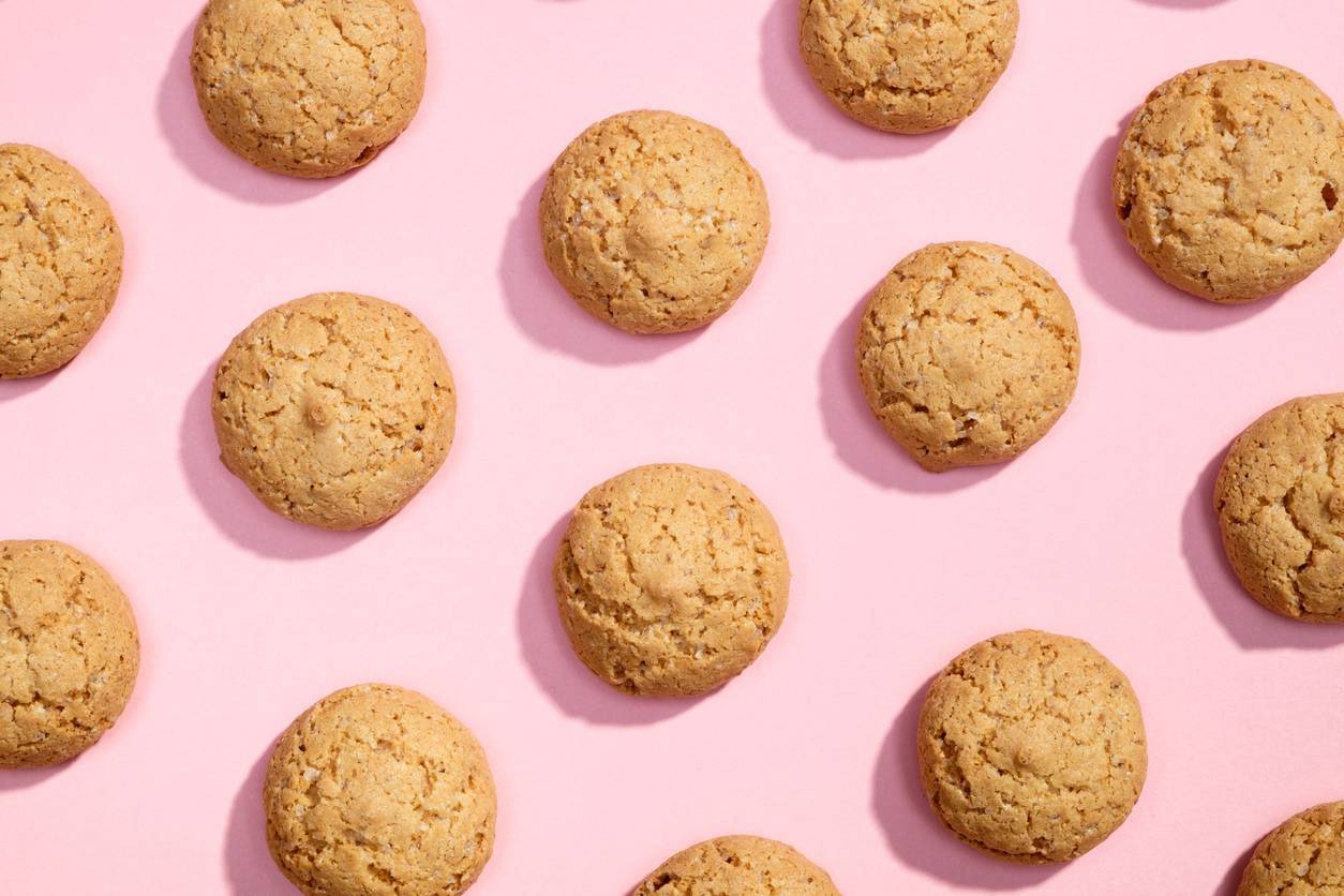 Pattern of sweet cookies on pink background