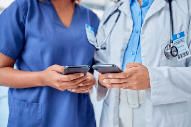 doctor and nurse on smartphones reviewing information on intranet