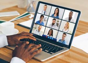 images of medical professionals on a laptop screen during a teleconference