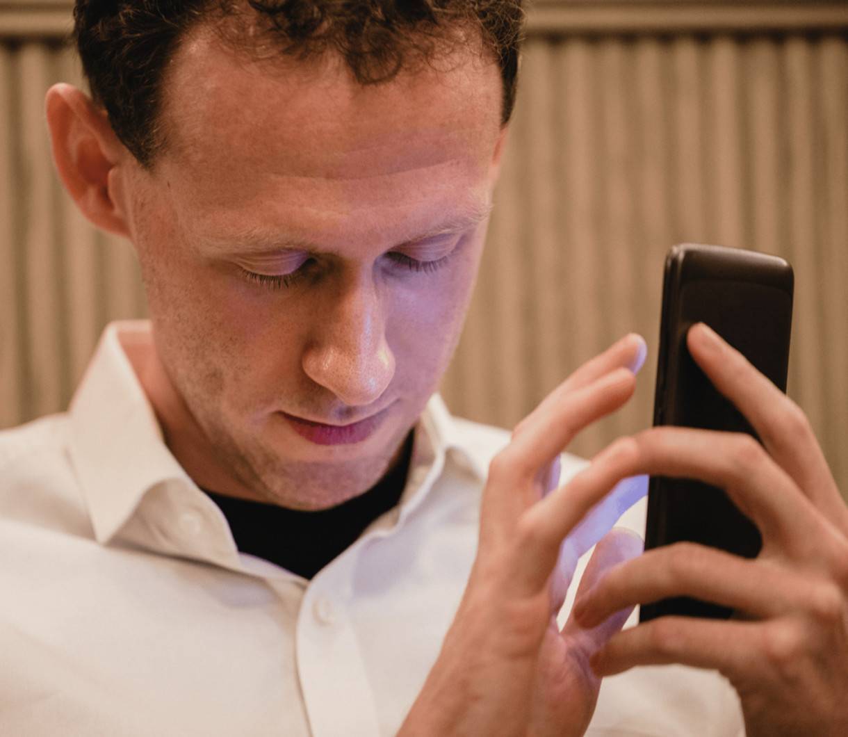 photo of a visually impaired man using an accessible mobile app