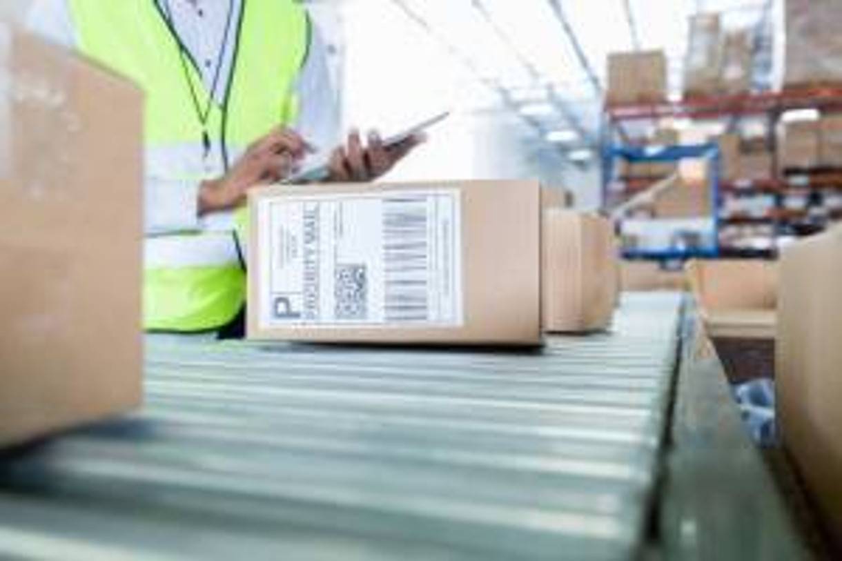 mail packages on a conveyer belt in a distribution center