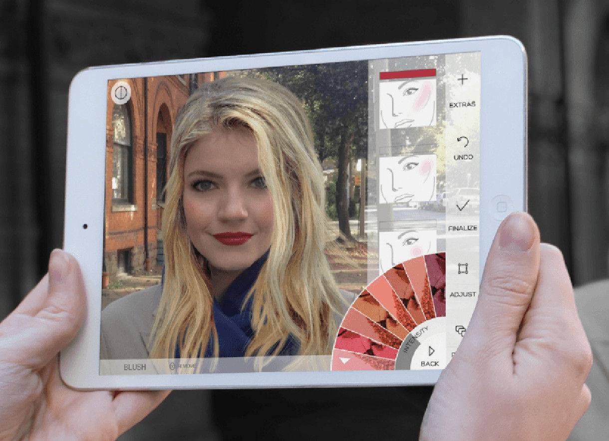 A woman using the Modiface app