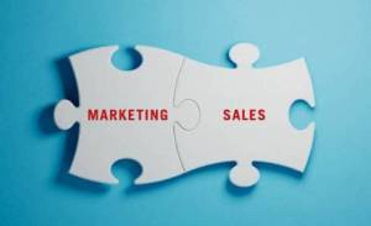 puzzle pieces labeled marketing and sales connecting