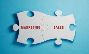 puzzle pieces labeled marketing and sales connecting